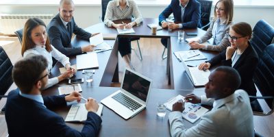 Businespeople at panel discussion in board room